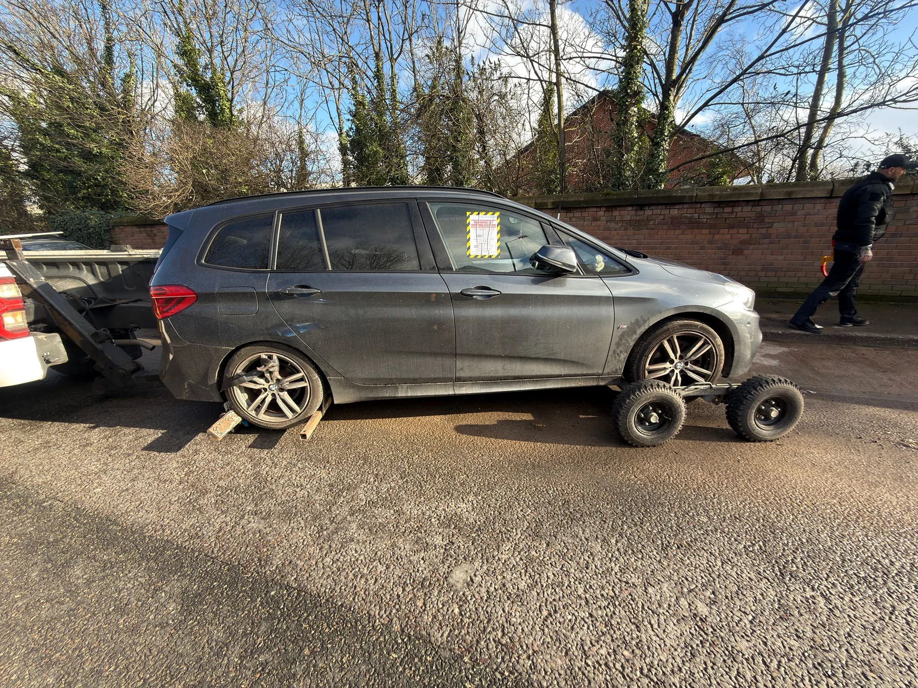BMW supported by a spec lift and recovery dollies