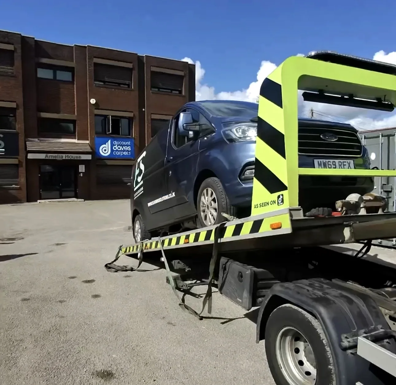 Dark van loaded behind an Iveco recovery gantry