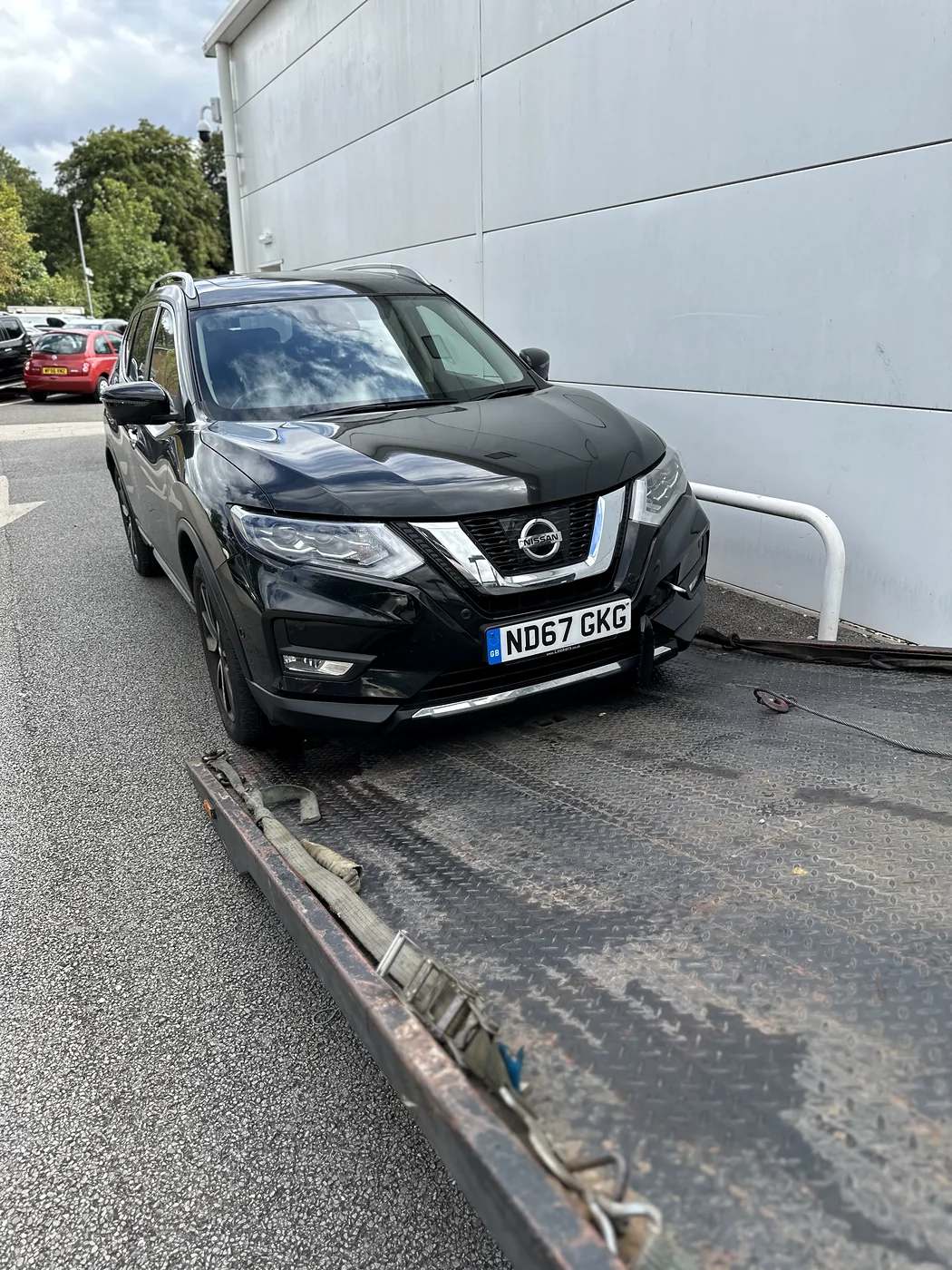 Black Nissan positioned at the foot of a recovery ramp