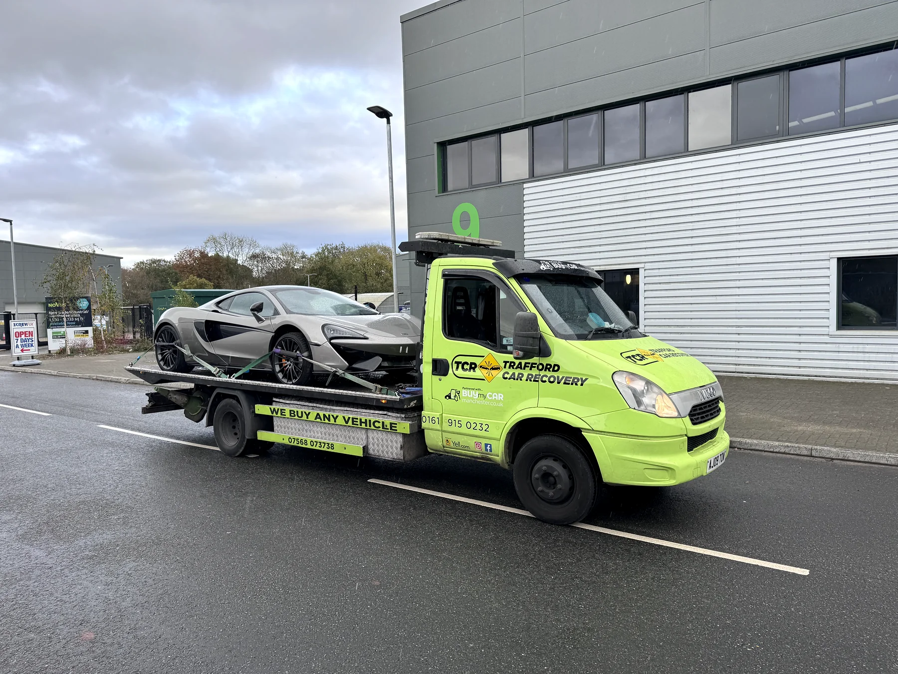 Wider view of a Trafford truck transporting a McLaren