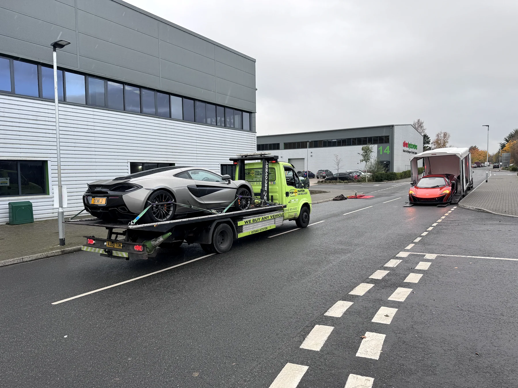 Recovery truck and secured McLaren viewed from behind