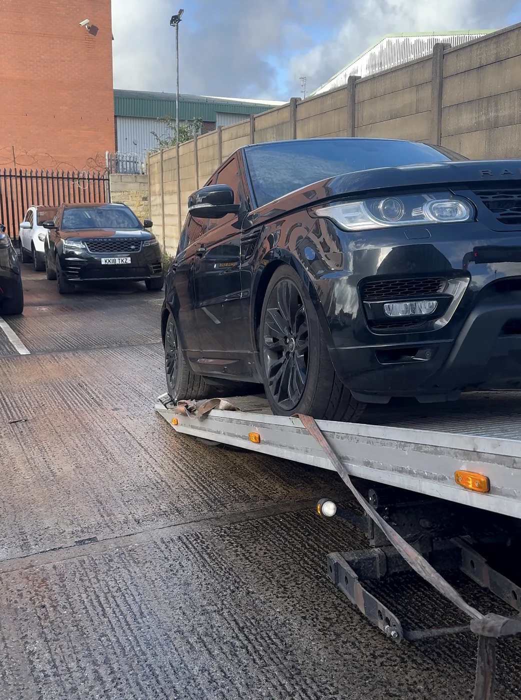 Dark SUV loaded on a recovery truck