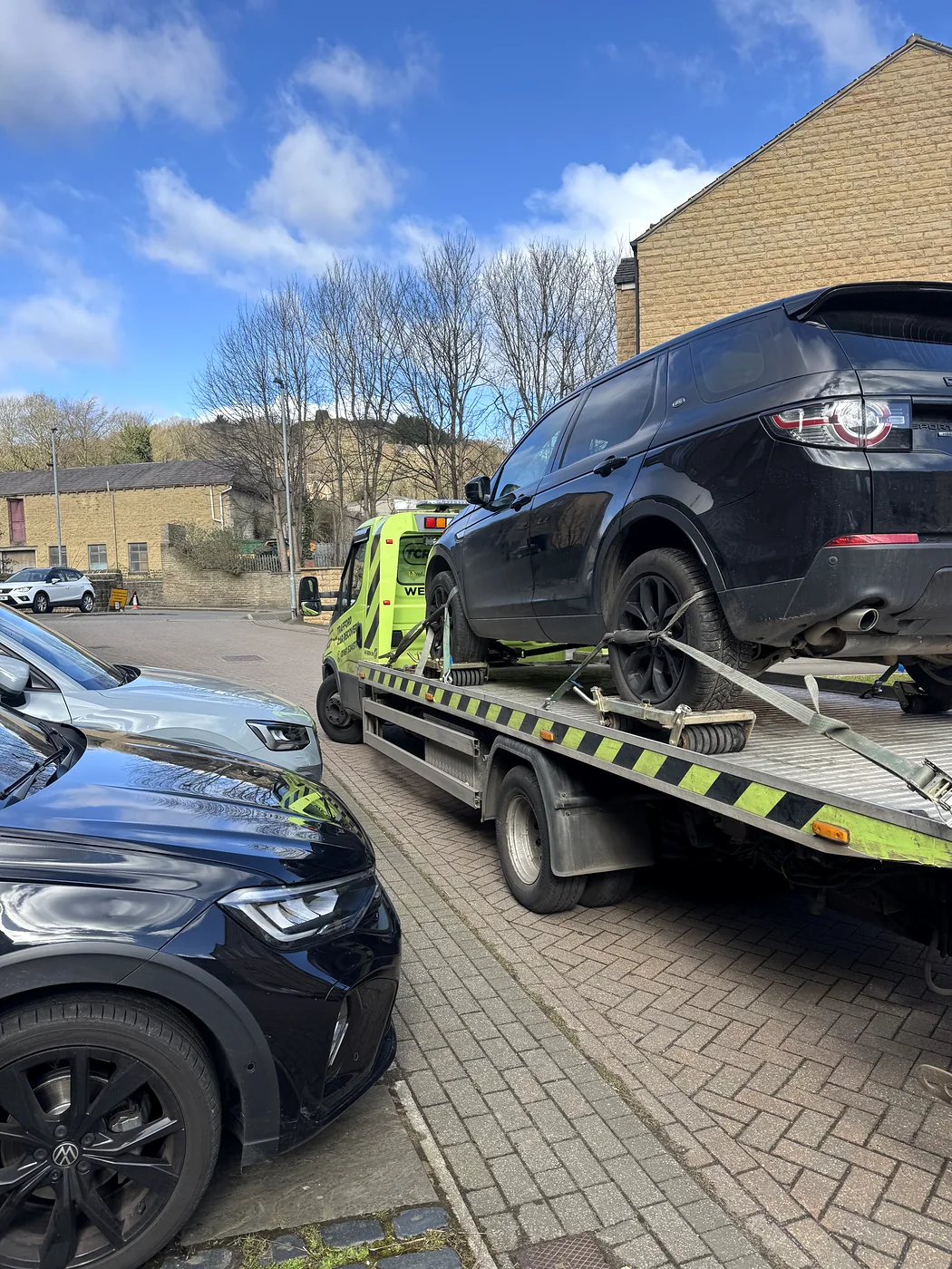 SUV on a recovery bed in a restricted driveway